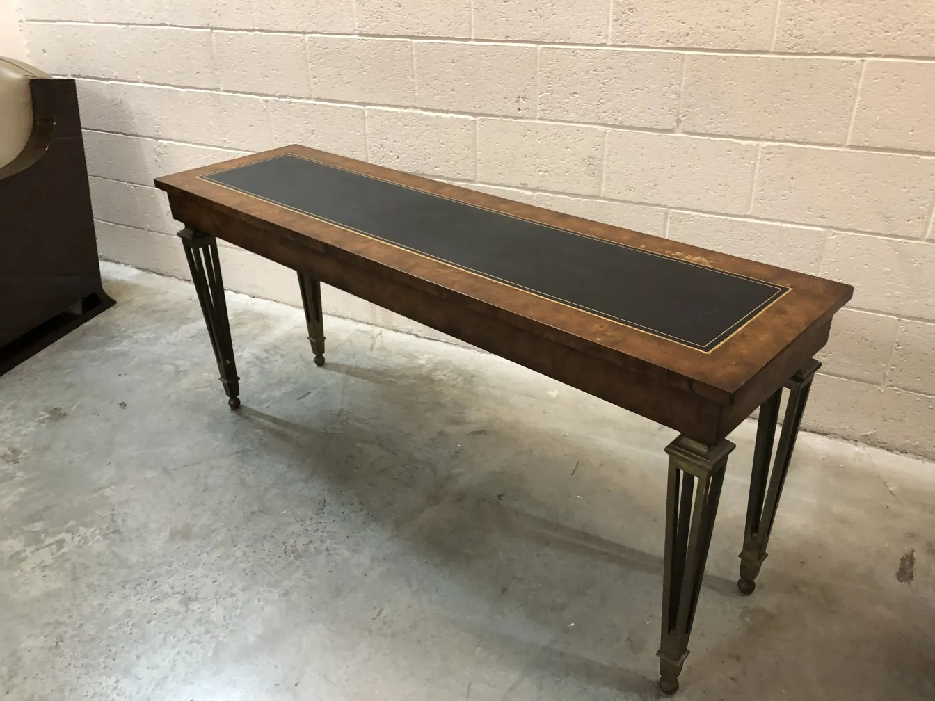 antique console table with black top and metal legs
