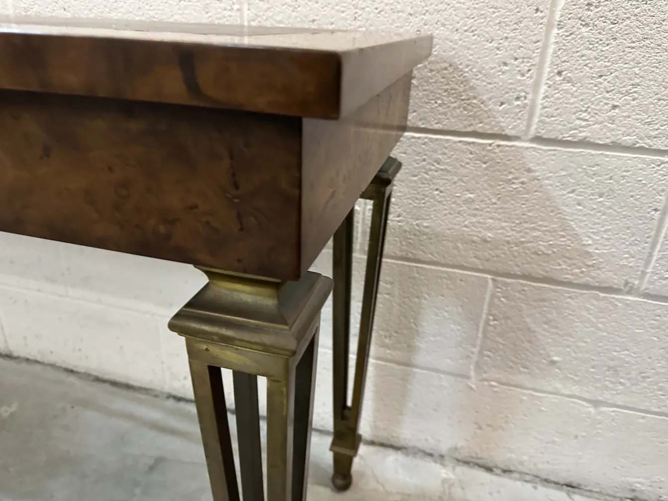 antique console table with gold legs in neutral setting