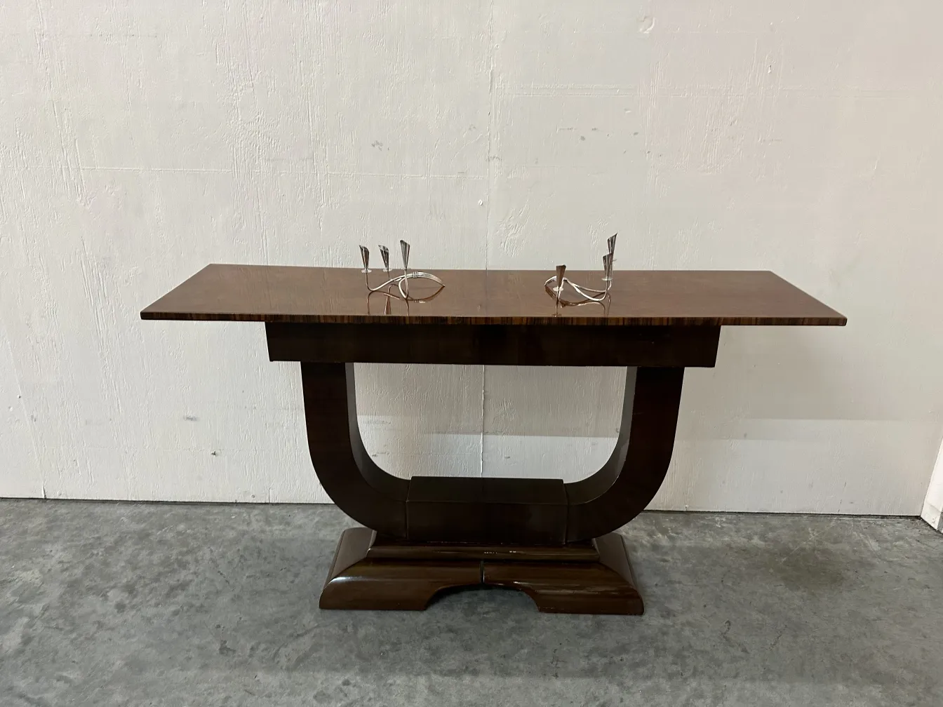 Antique console table with a sleek design and smooth finish, set in a cozy environment.