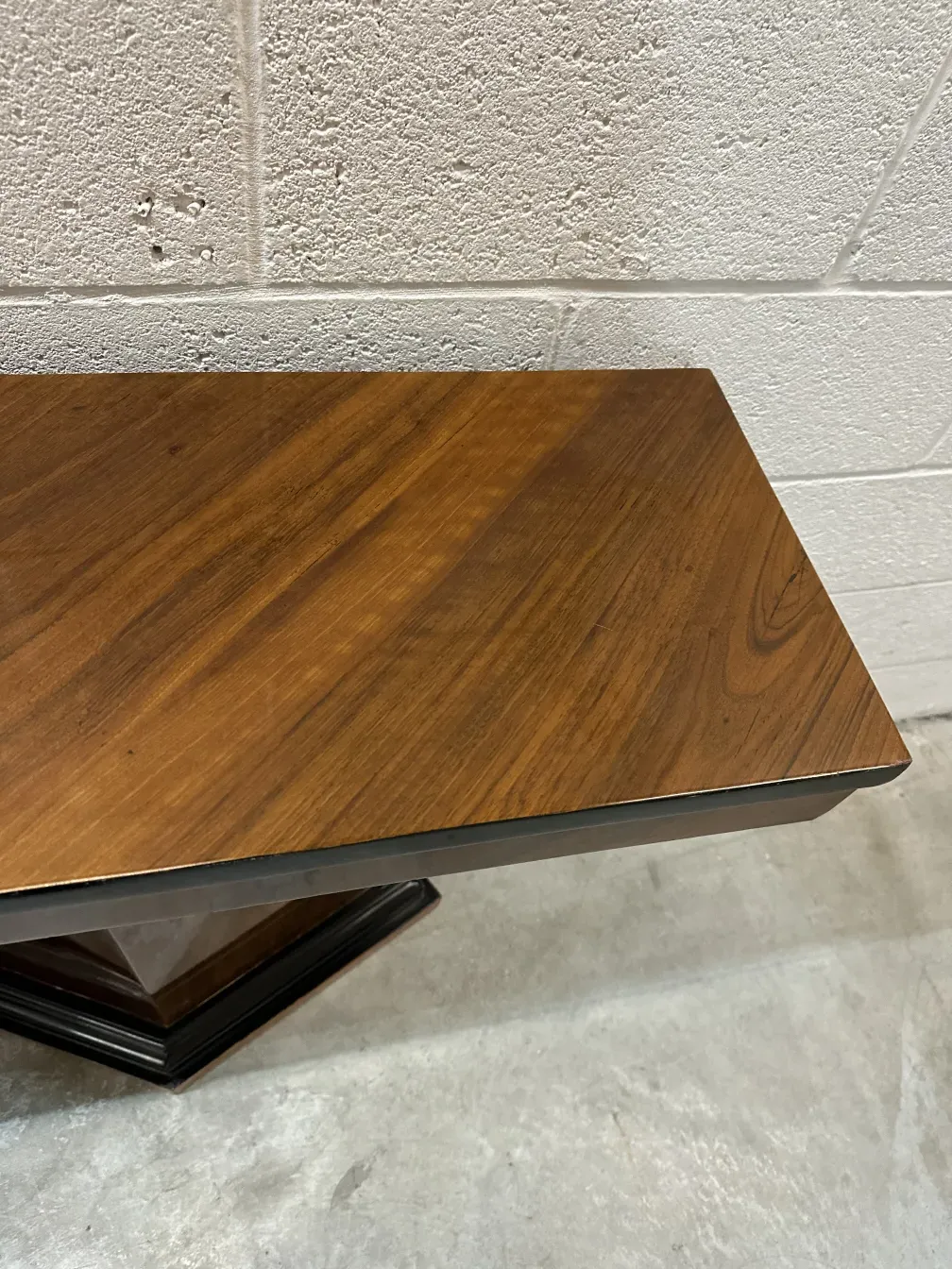 Side view of two antique consoles in a neutral setting