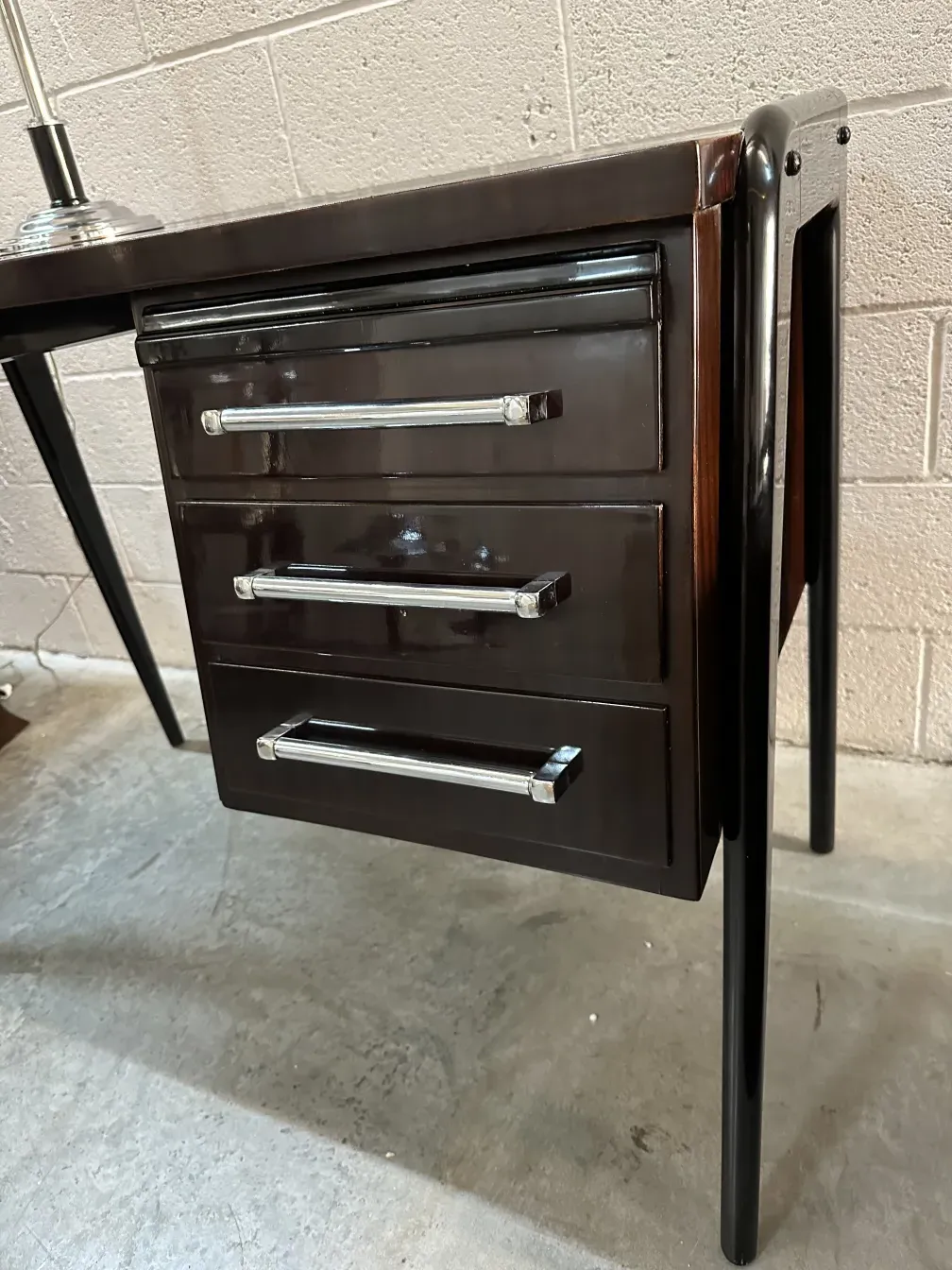 antique desk featuring three drawers and elegant style