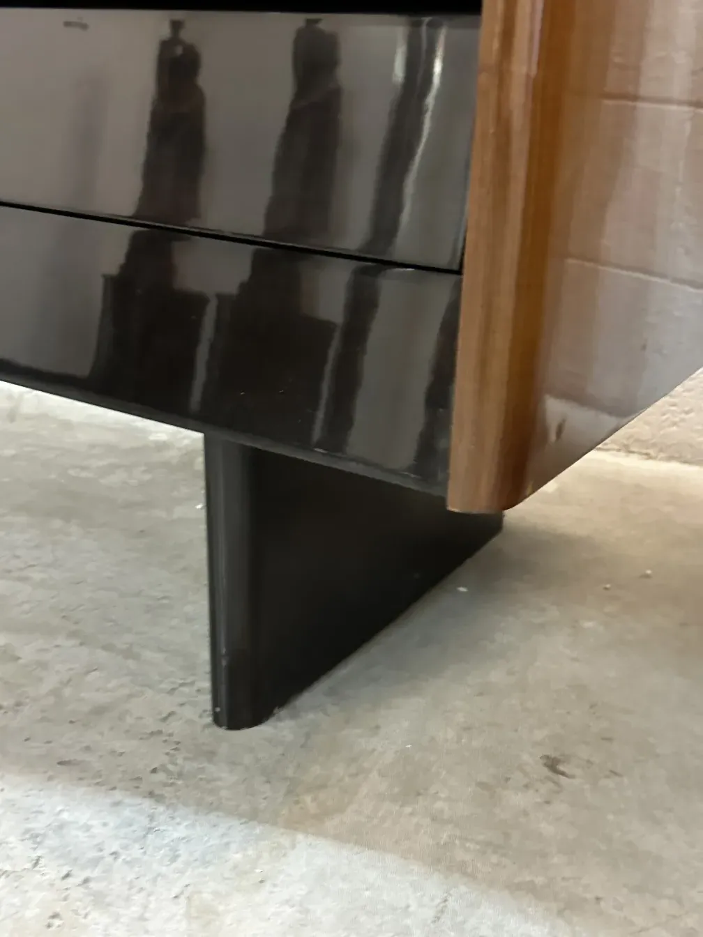 Antique desk with a glossy finish and elegant lines, set in a modern environment.