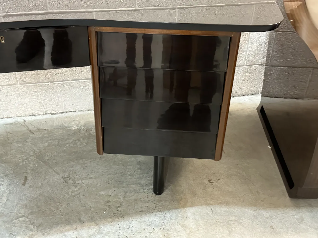 curved antique desk with several drawers