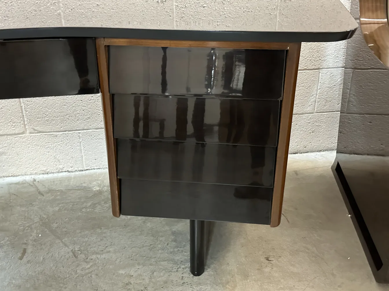 View of an antique desk with two dark drawers in a room.