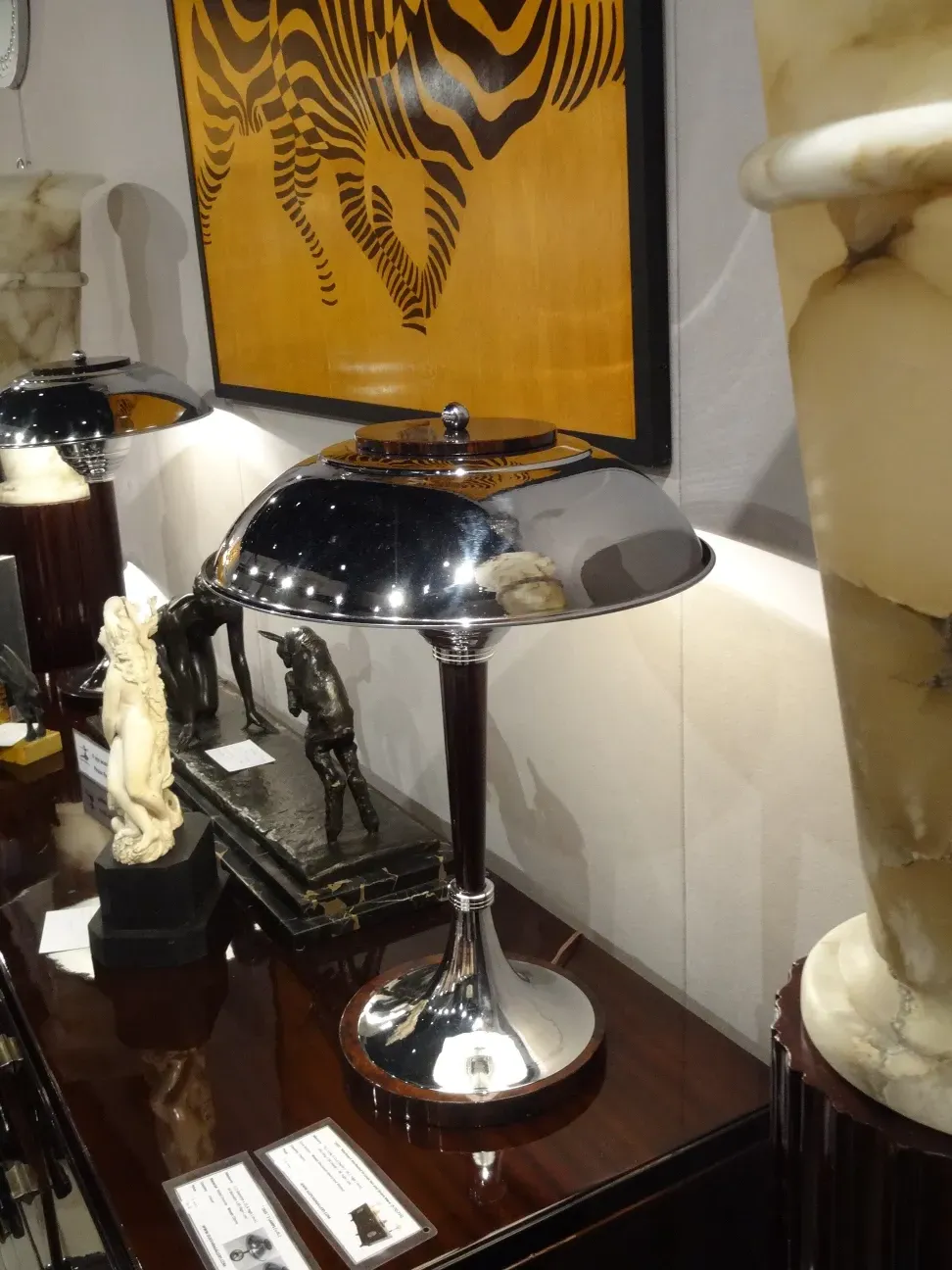 two antique table lamps with elegant bases and artistic details, surrounded by decor