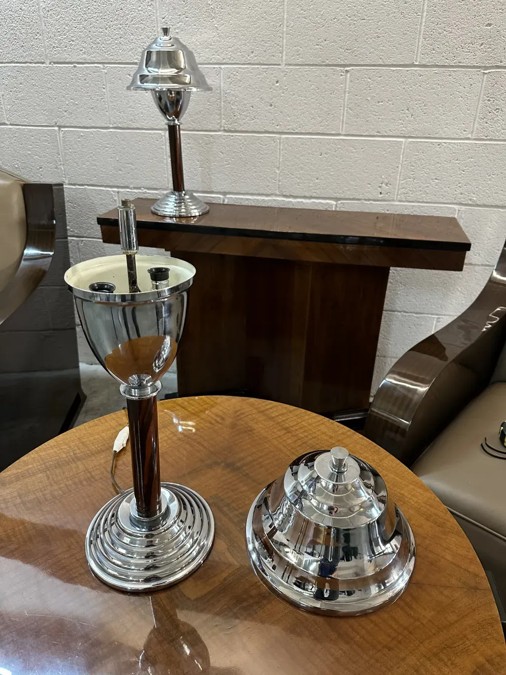 Two antique table lamps next to a stylish setting.