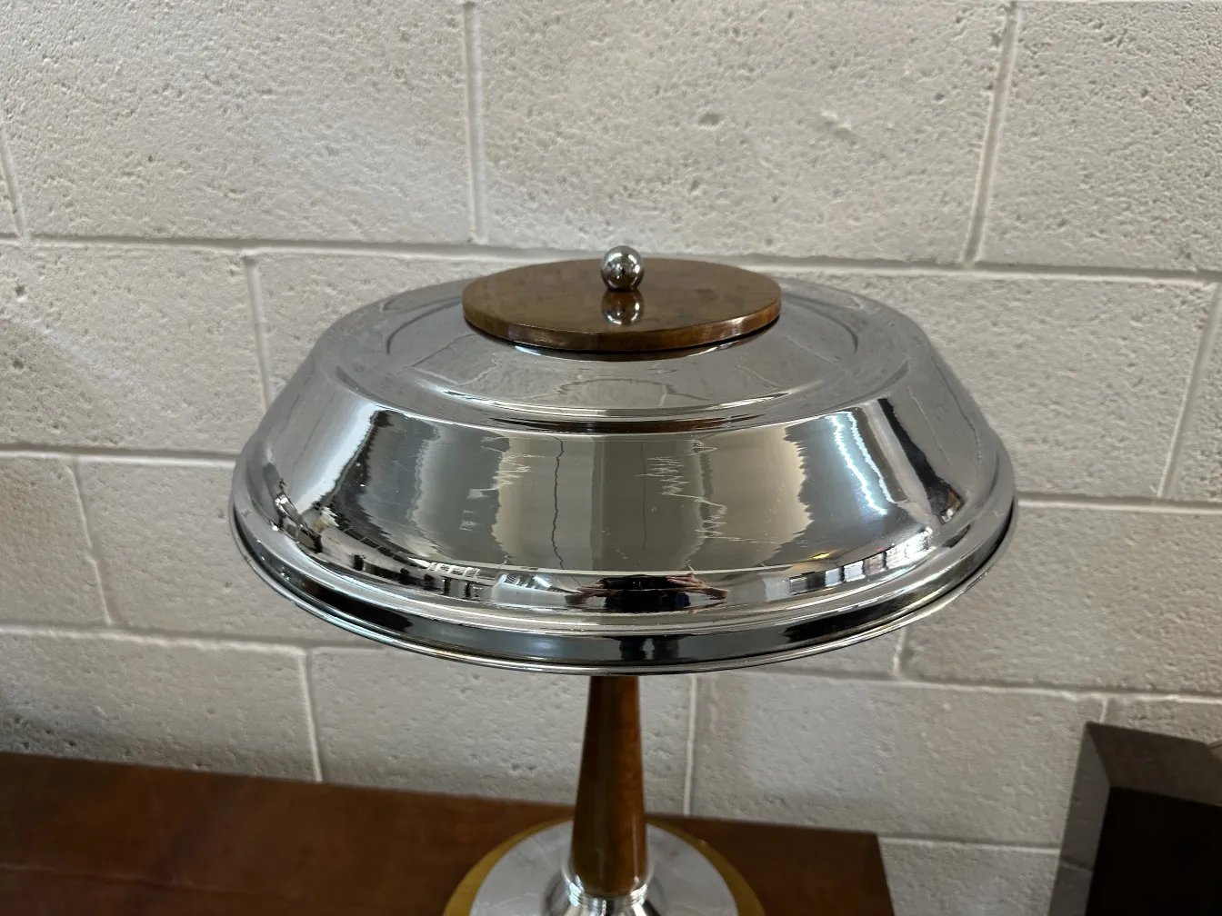 two antique table lamps with a shiny, elegant design on a table.