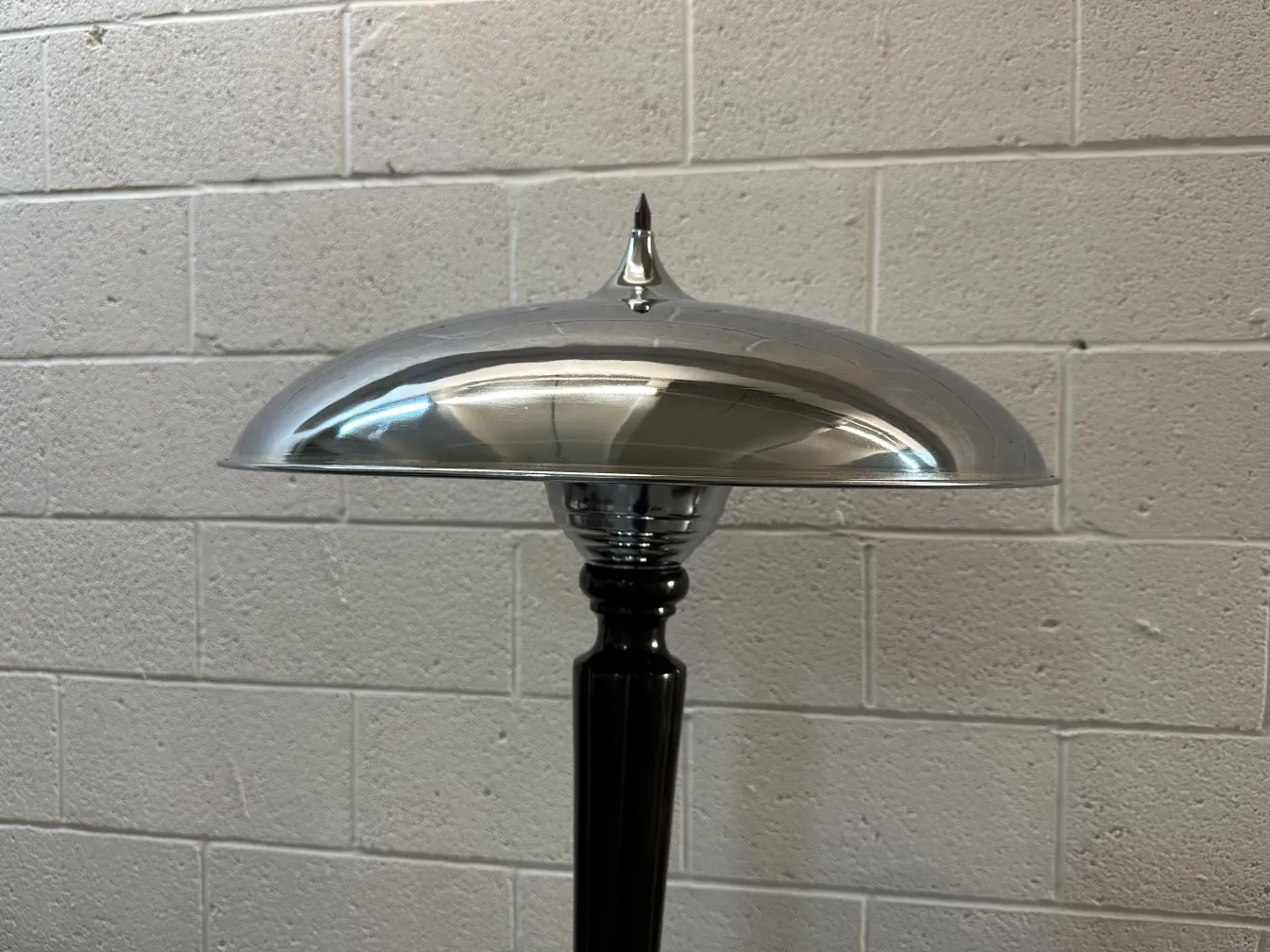 Close-up view of 2 vintage table lamps with an elegant base and wide shade