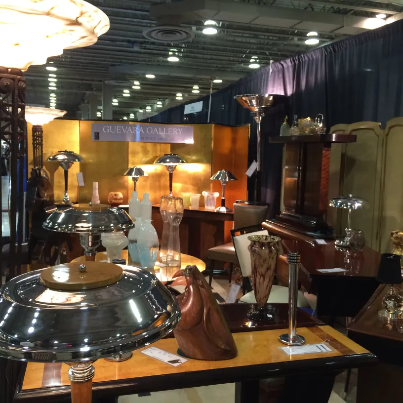 two antique table lamps in a gallery with other lamps