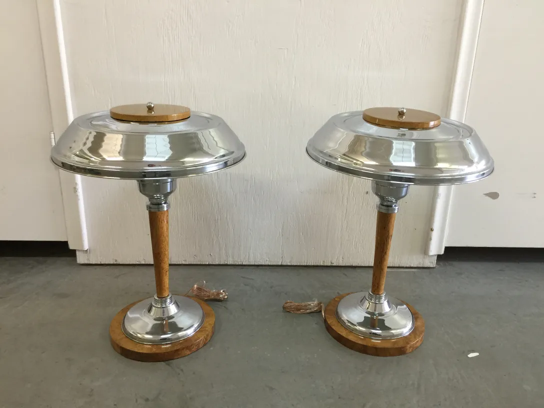 two antique table lamps with shiny bases and elegant details, in a minimalist setting