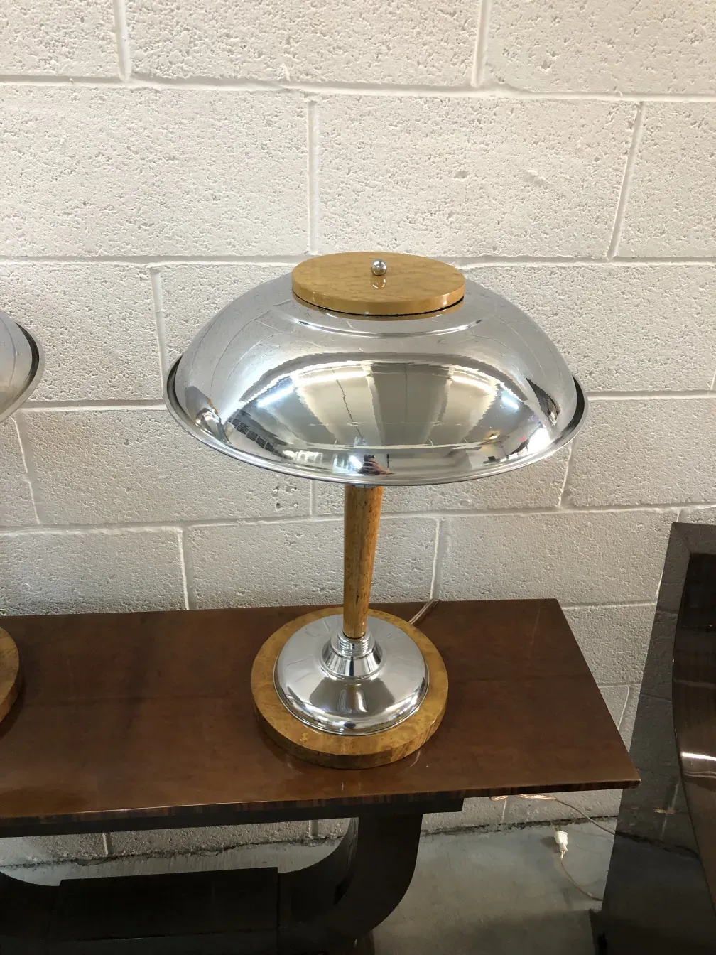 2 antique table lamps with chrome details and circular bases in a modern setting