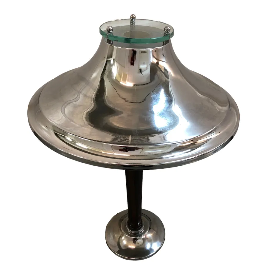 Antique table lamp with shiny base and elegant shape, in a well-lit room.