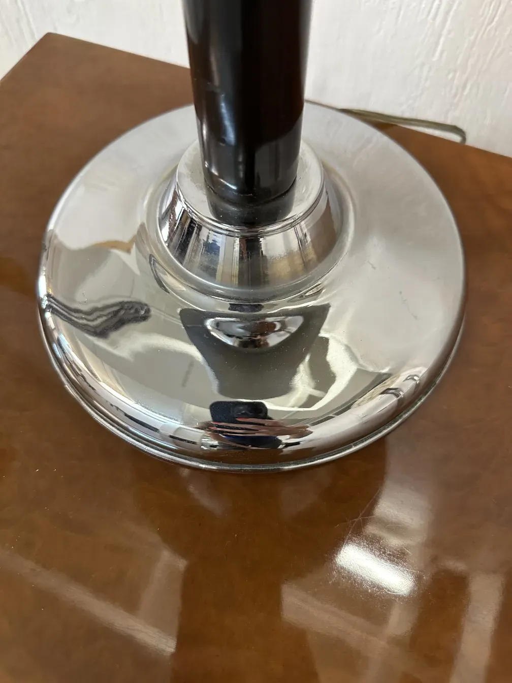 antique table lamp with a shiny base and elegant design on a brown background