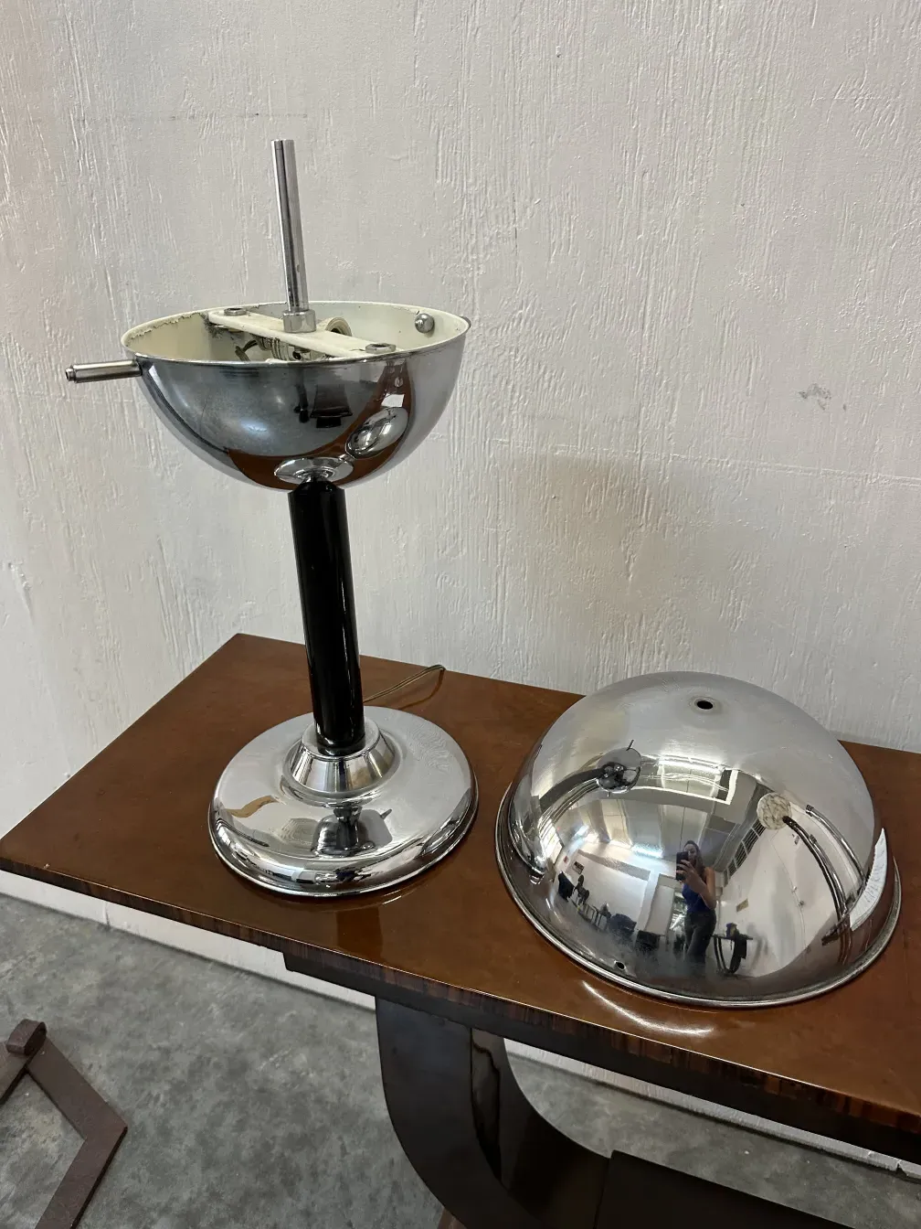 antique table lamp with shiny finish and elegant design, placed on a wooden surface with silver colors