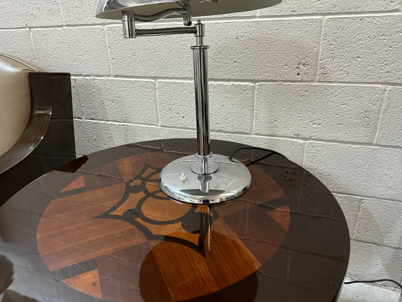 Antique table lamp with chrome base on decorative table