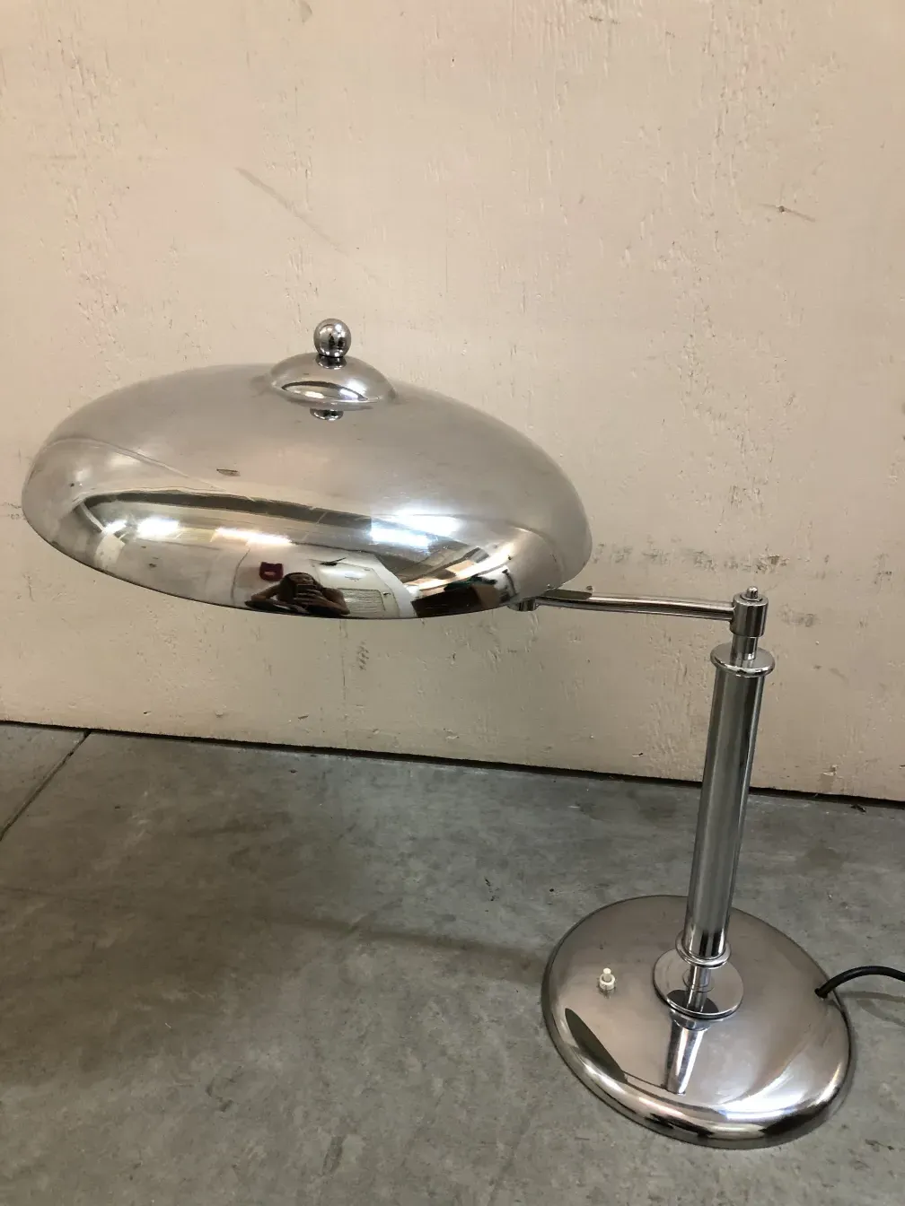 antique table lamp with a round shape and shiny finishes against a neutral background, elegance and sophistication