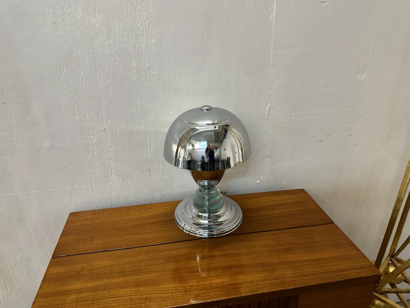 Antique table lamp with shiny base in a warm setting.