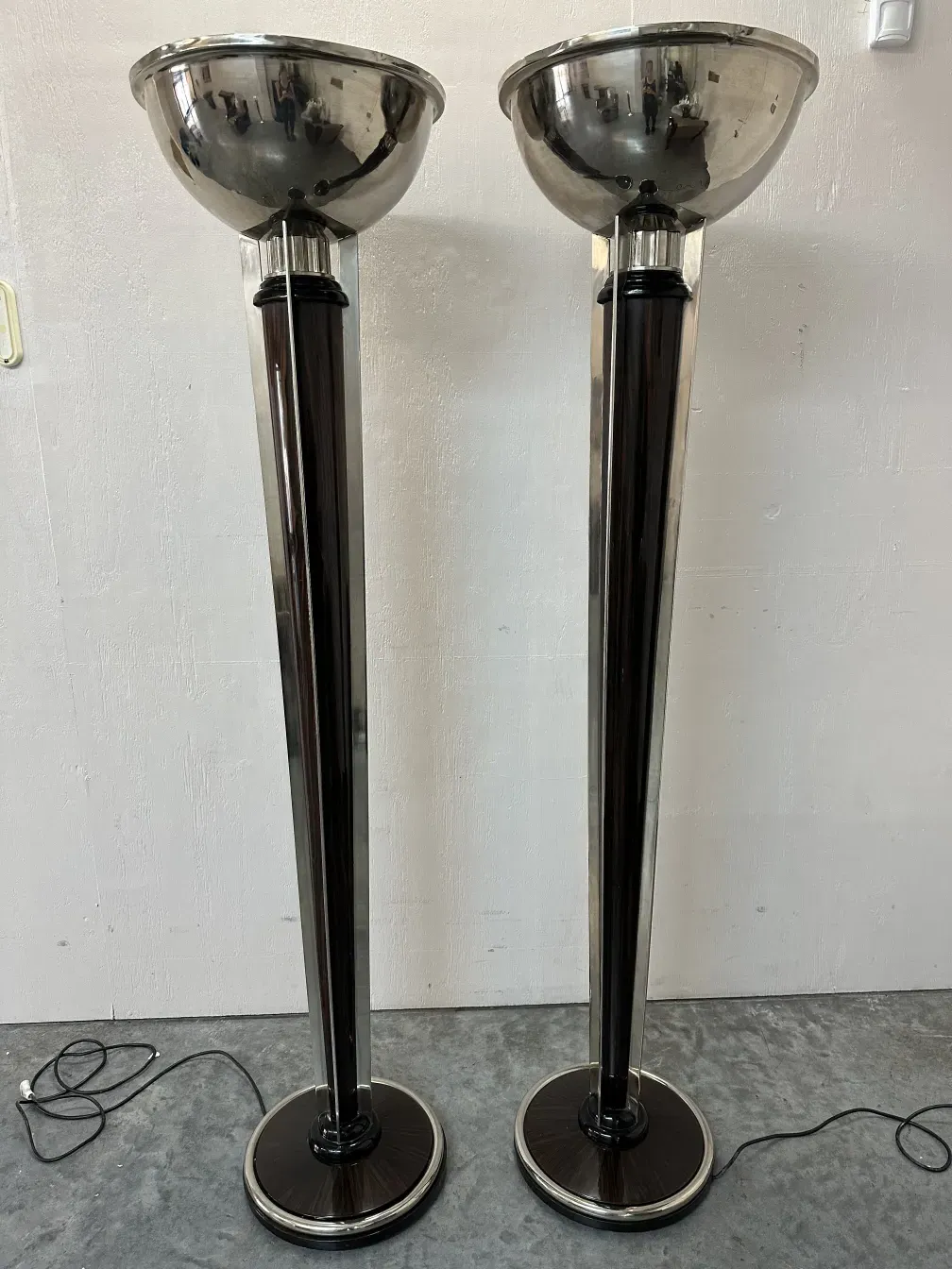 Two antique floor lamps with a sleek design in a contemporary setting