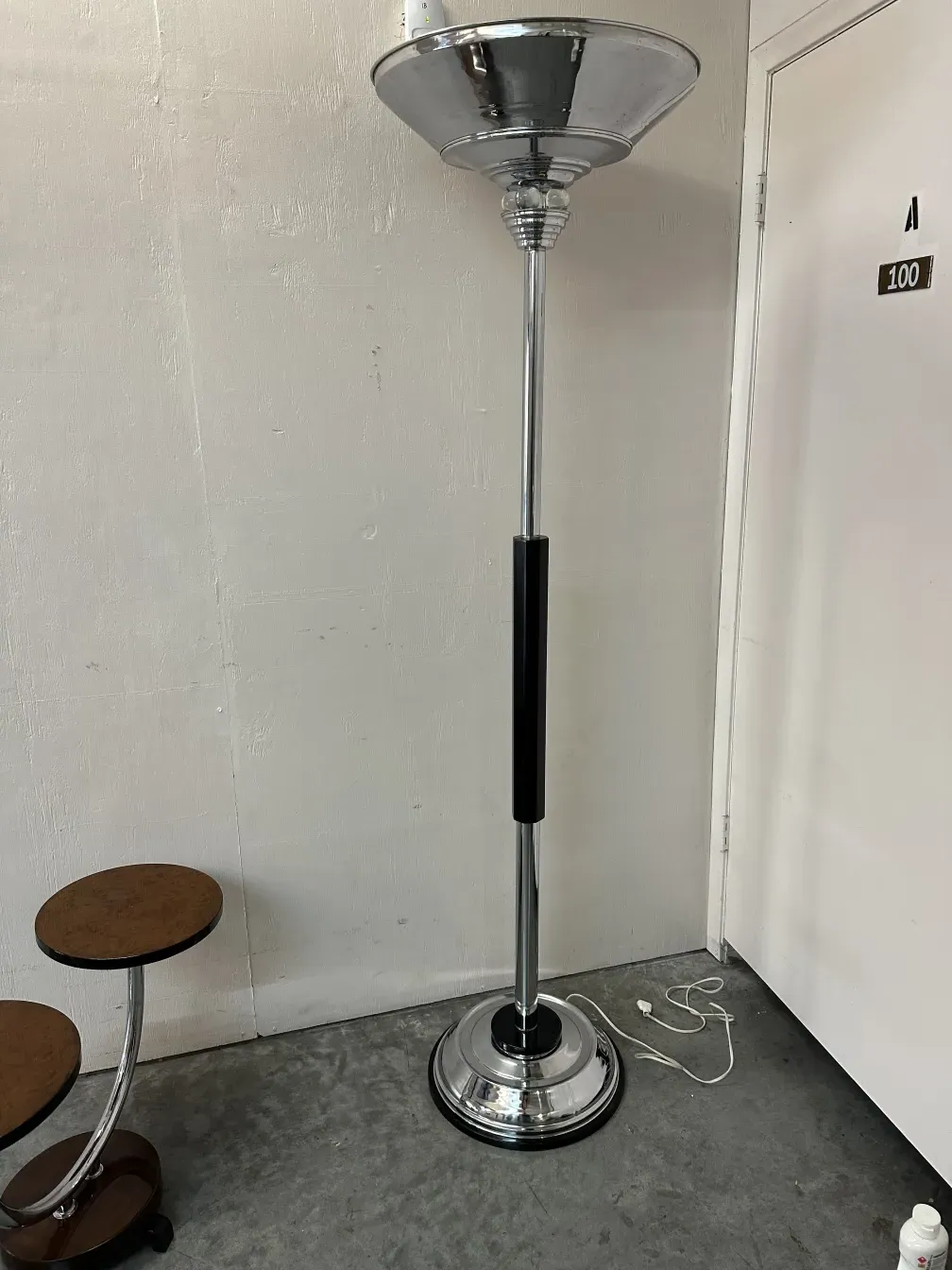 Two antique floor lamps in a neutral setting.