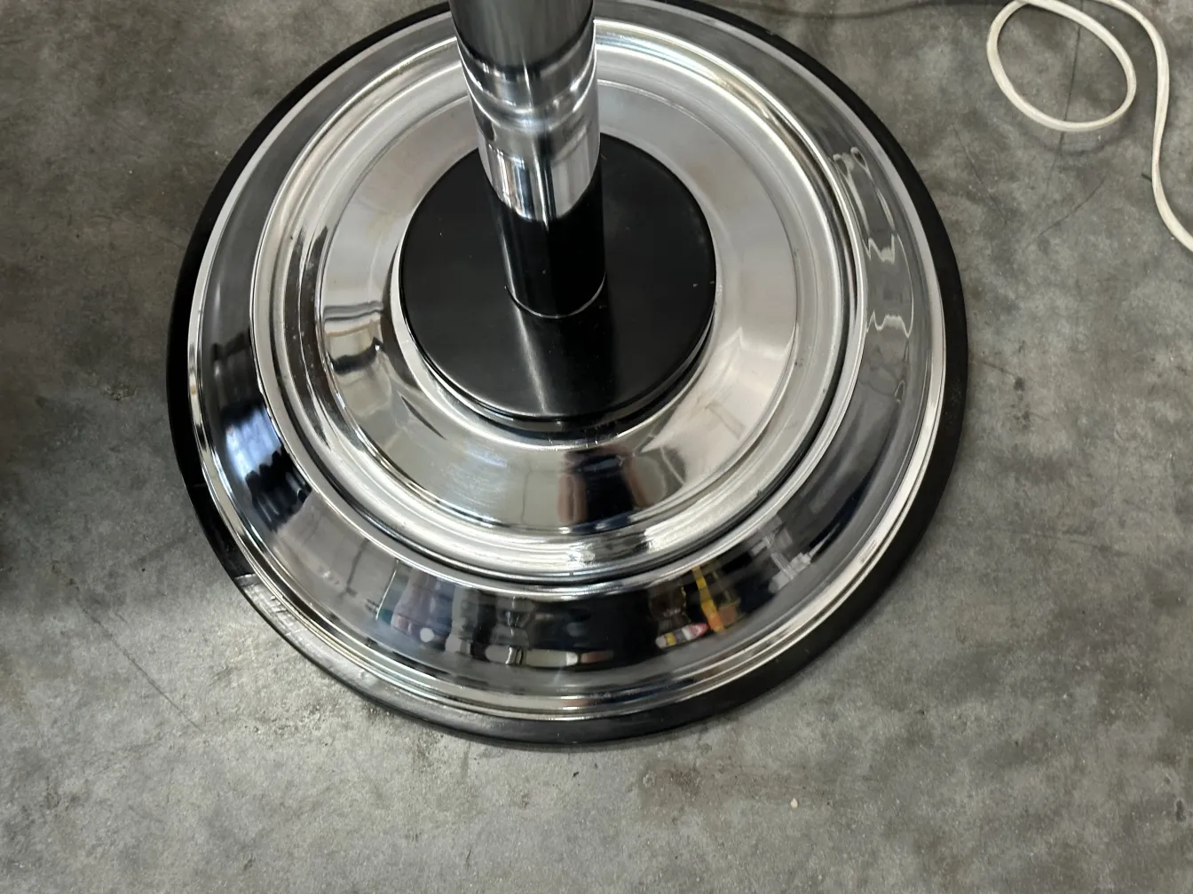 Close view of the base of two antique floor lamps