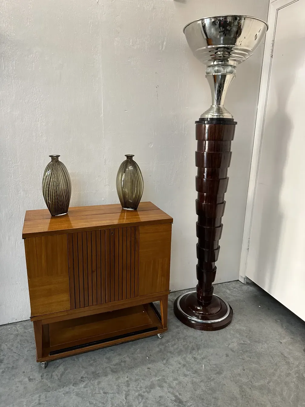 Two antique floor lamps with decorative base in a cozy setting