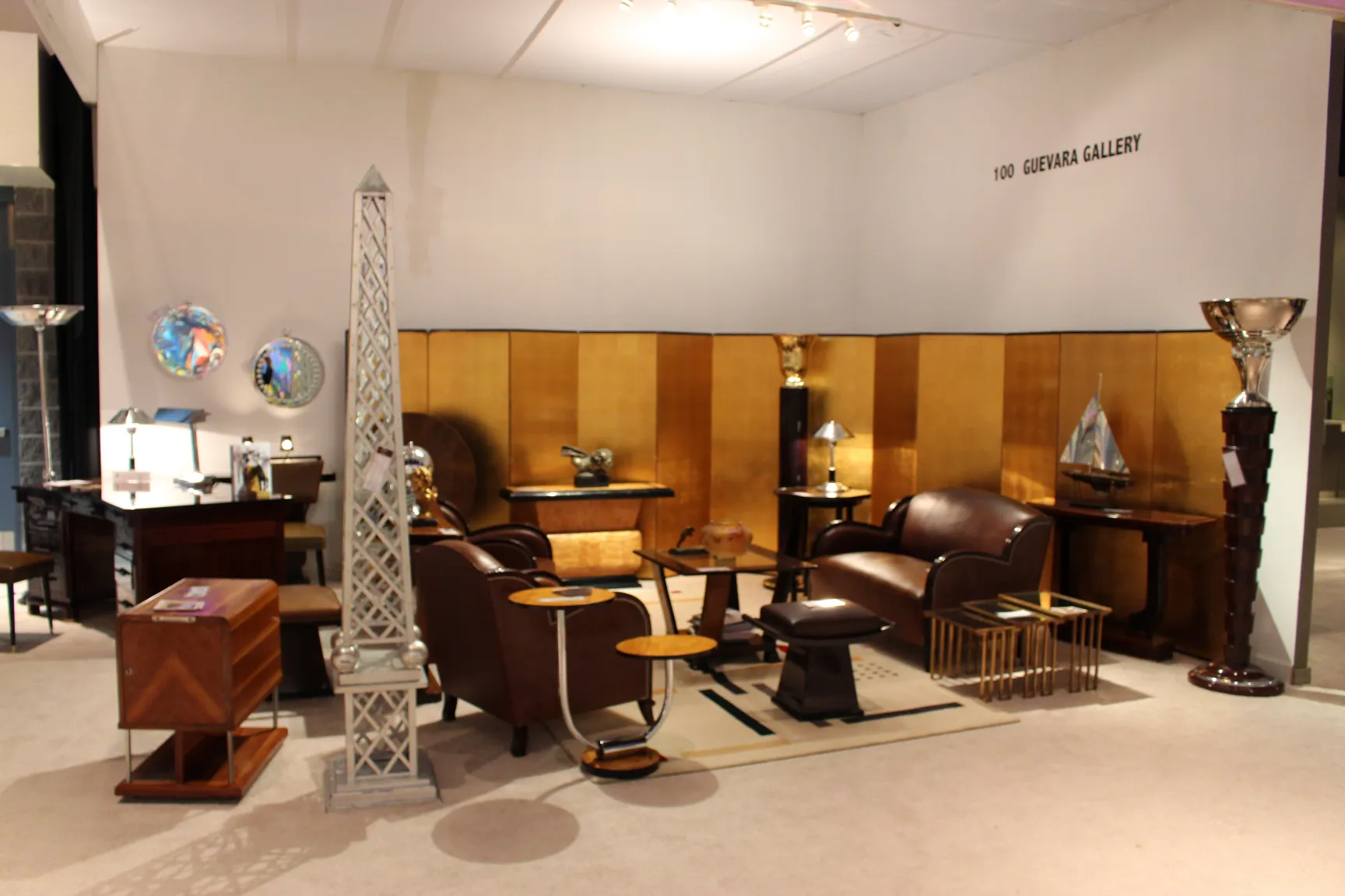 two antique floor lamps in gallery setting with furniture