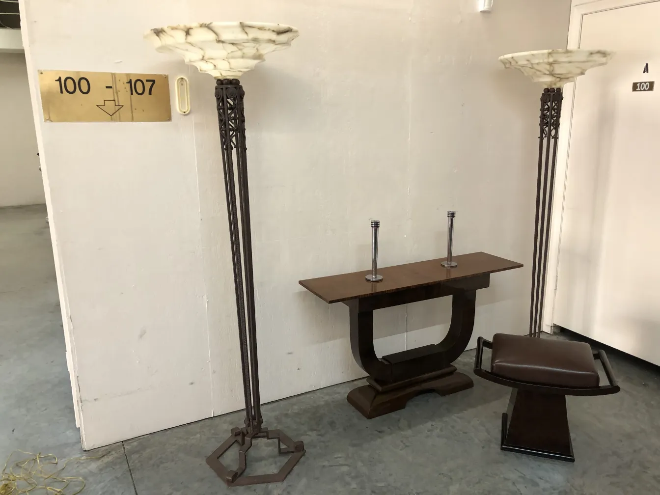 Two antique floor lamps with elegant shades in a modern setting.