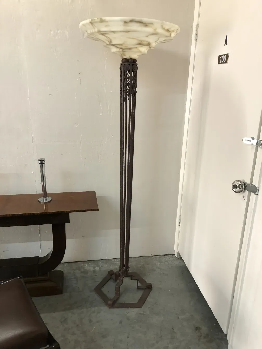 Two antique floor lamps in a simple setting.