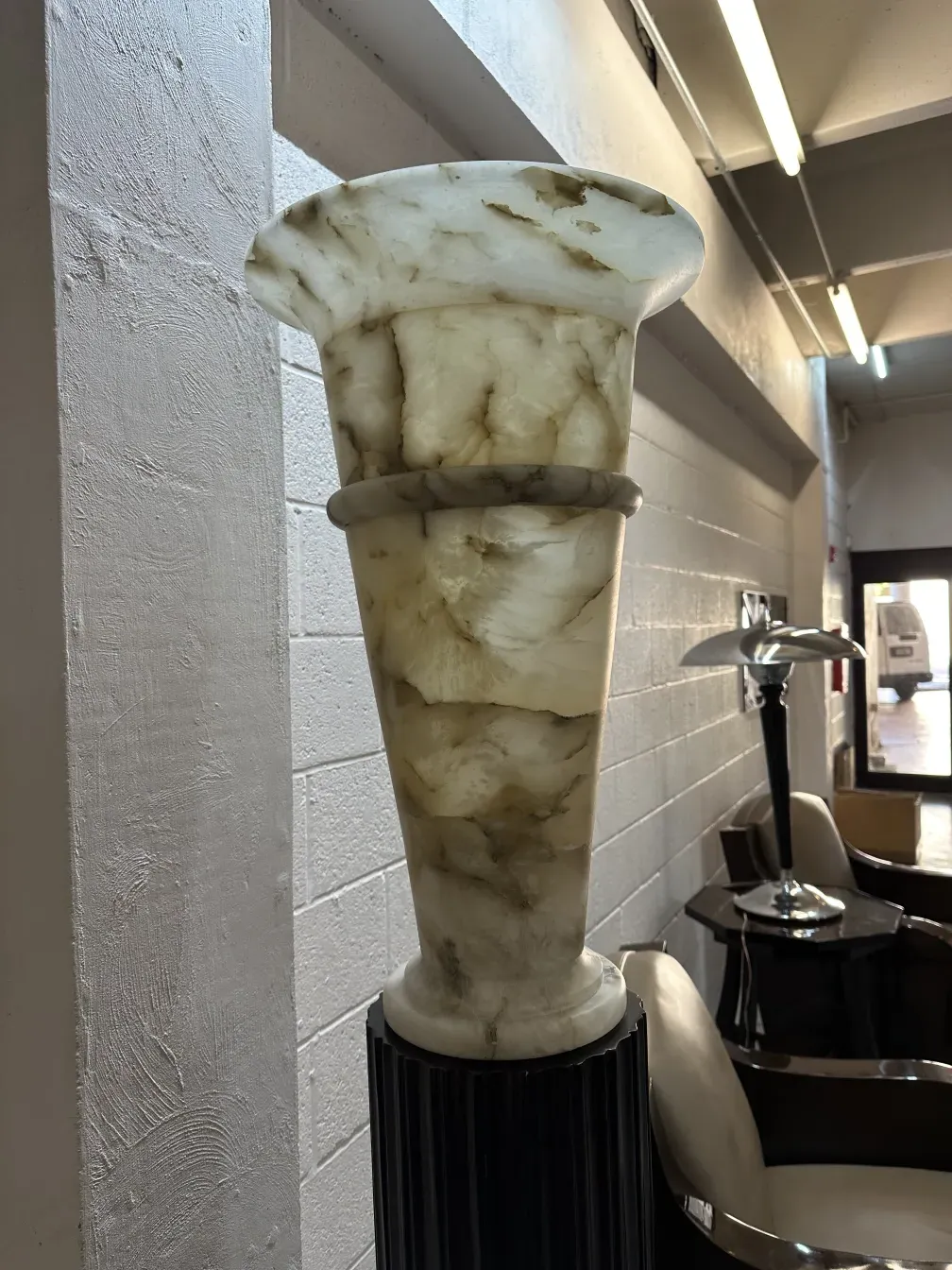 Side view of two antique floor lamps with elegant bases in a modern setting.