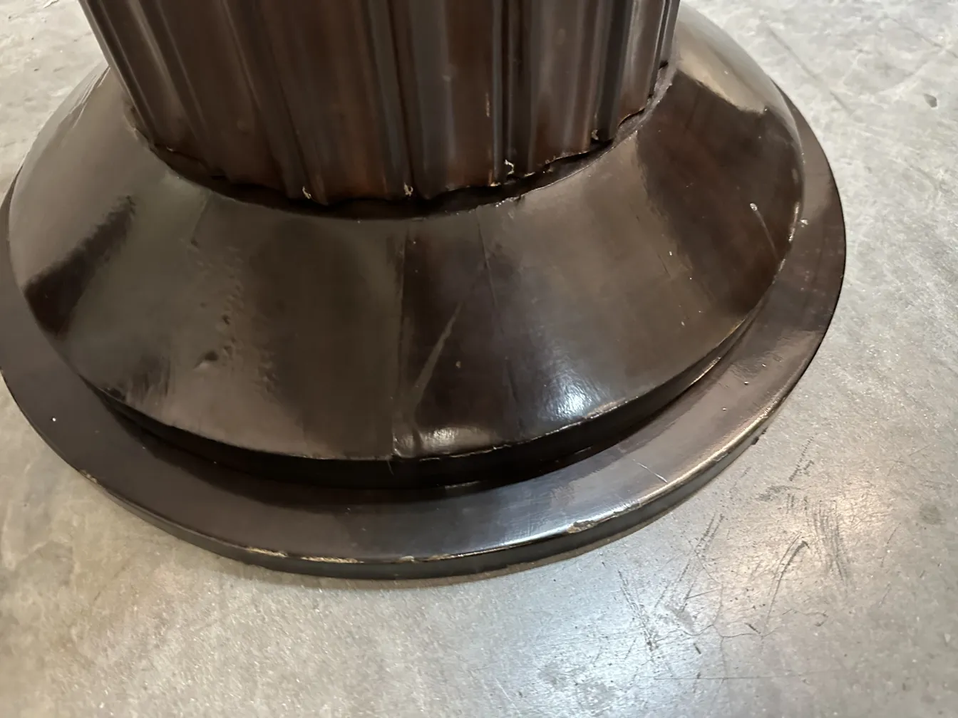 Detail of the base of 2 antique floor lamps in a warm setting