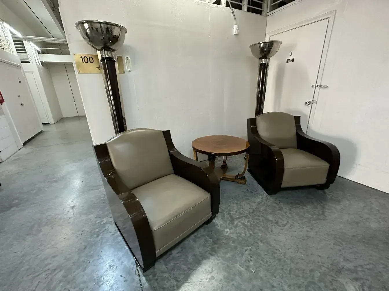 2 antique armchairs in a minimalist setting with table
