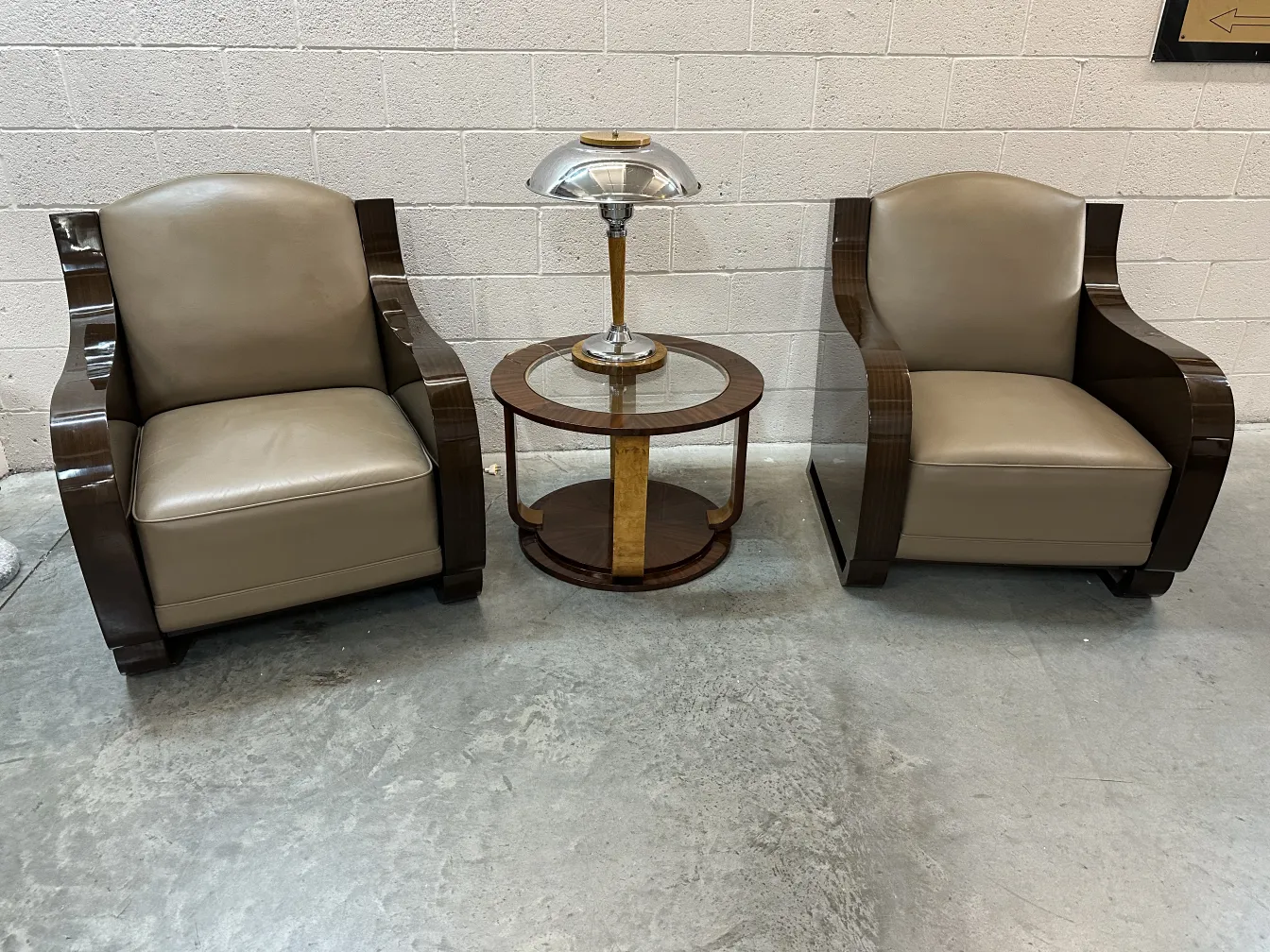 Two antique armchairs with elegant design and a side table