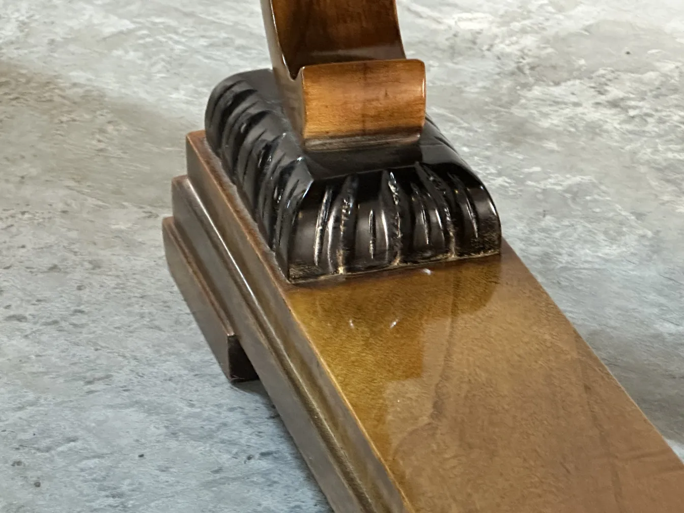 View of an antique coffee table with decorative base in a subtle setting.