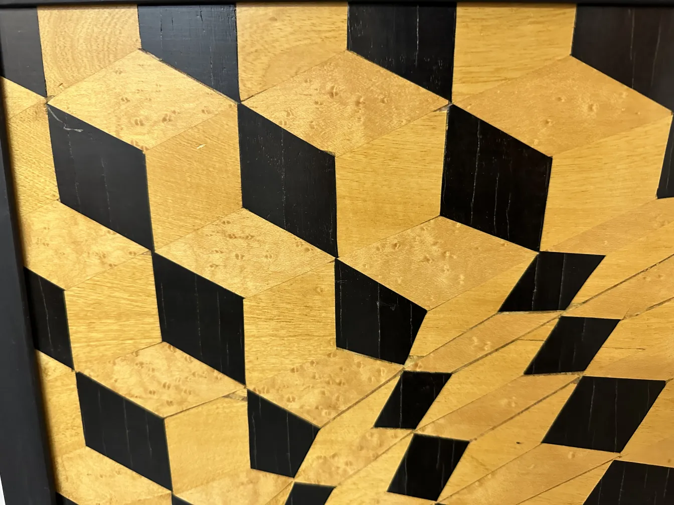 Detail of antique marquetry with geometric patterns and patina