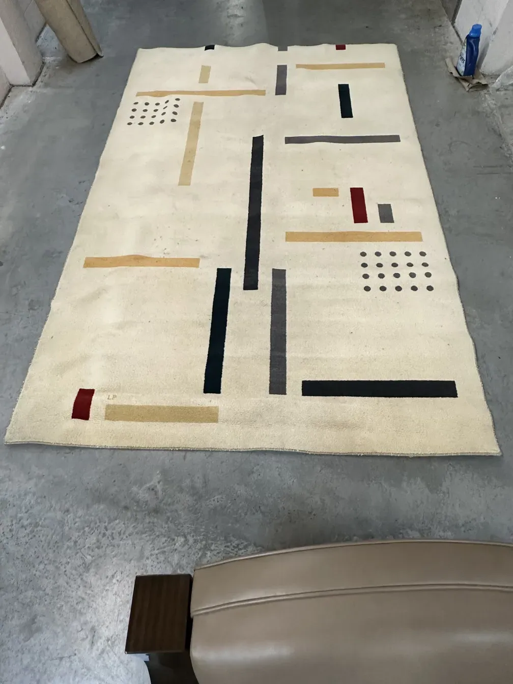 antique carpet with colorful geometric shapes on a light background