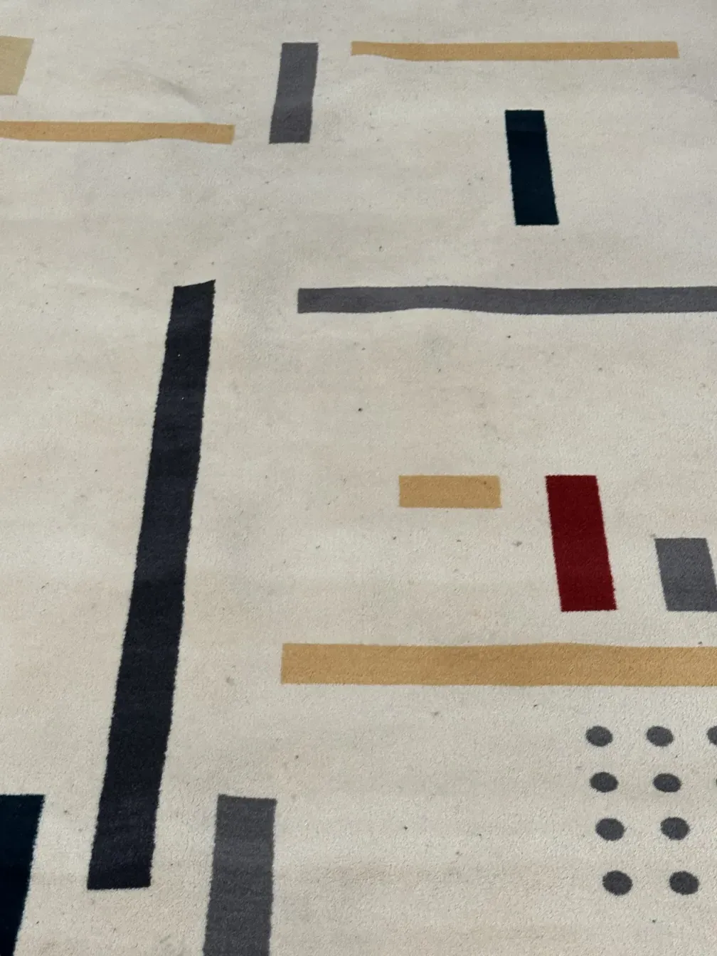 antique carpet with light background and geometric patterns