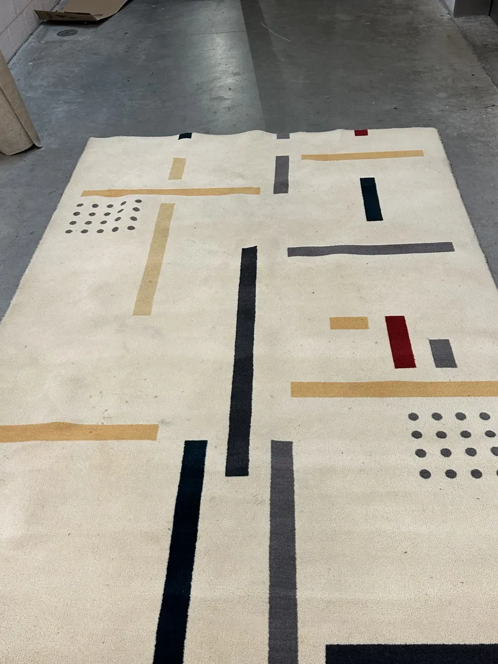 antique carpet with geometric patterns in light tones