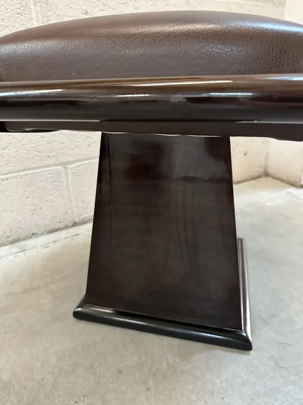 side view of an elegant antique sidewalk stool, neutral background