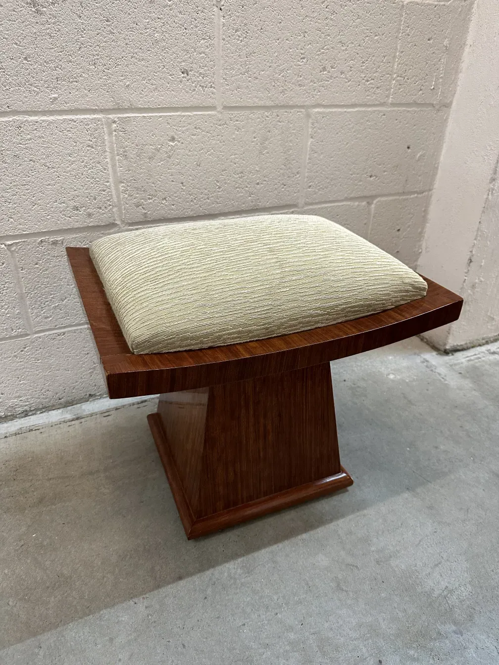 vintage stool with light cushion in a neutral setting