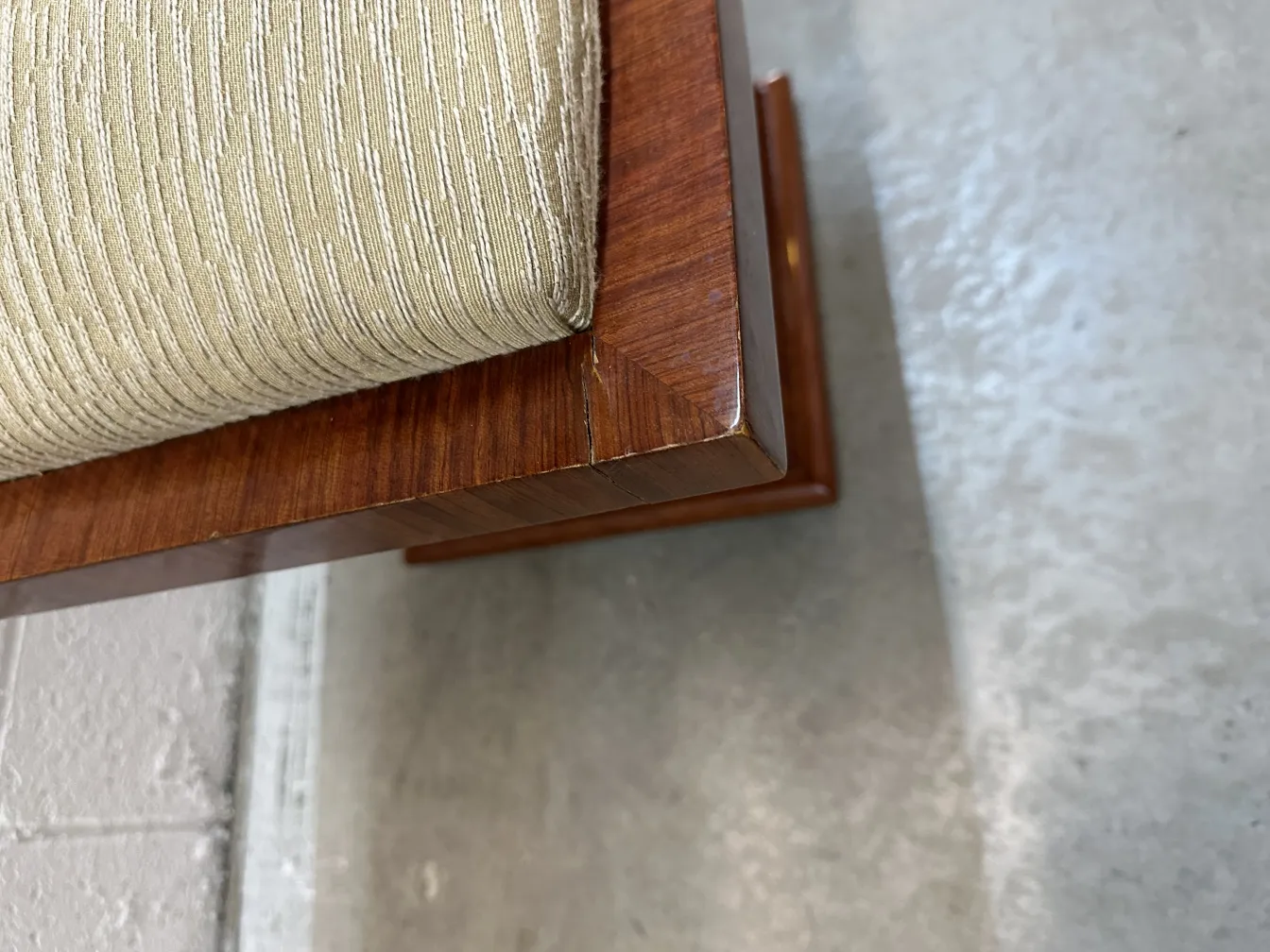 Top view of an antique sidewalk seat with a comfortable cushion and polished details in a modern environment.