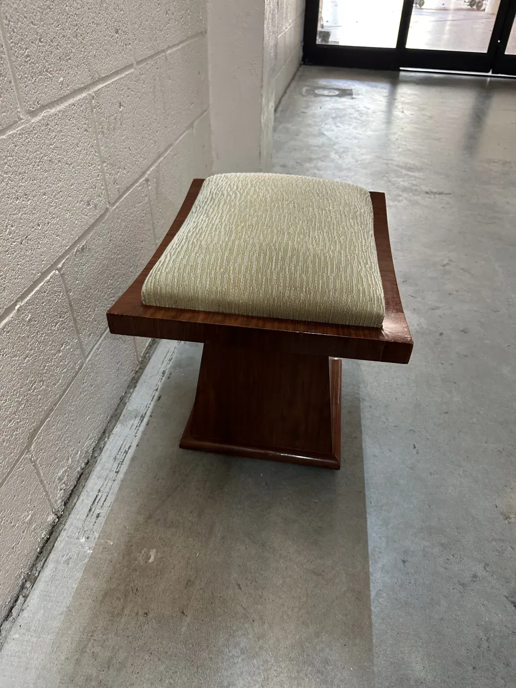 antique stool with padded seat and sturdy base
