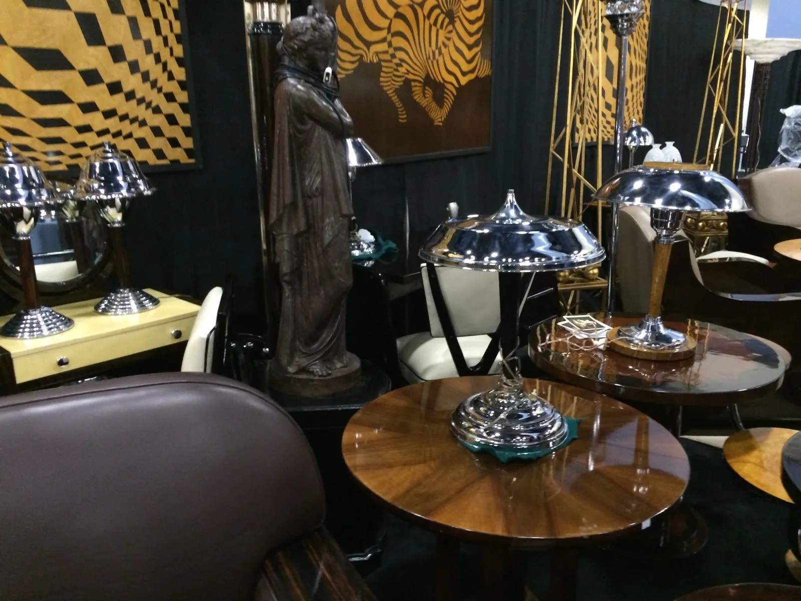 antique small table with round shape, bright lamps, and sculptural decorations around.