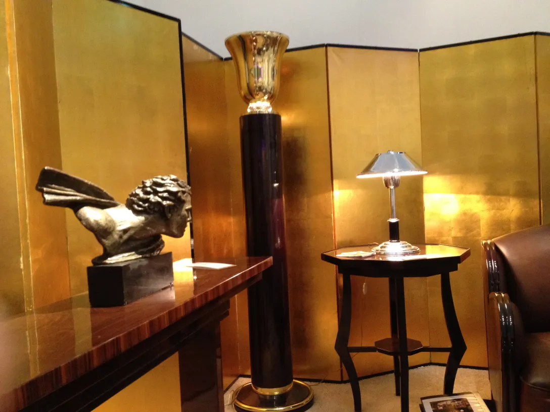 small antique table in an environment with elegant gold decorations