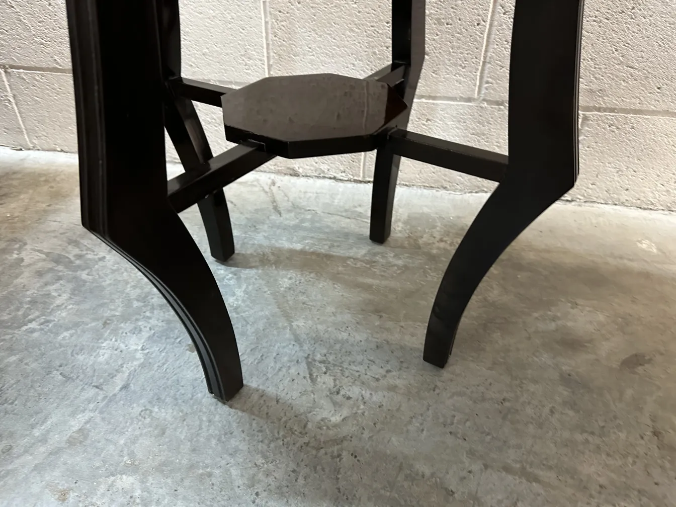 antique black small table with curved legs in a classic setting