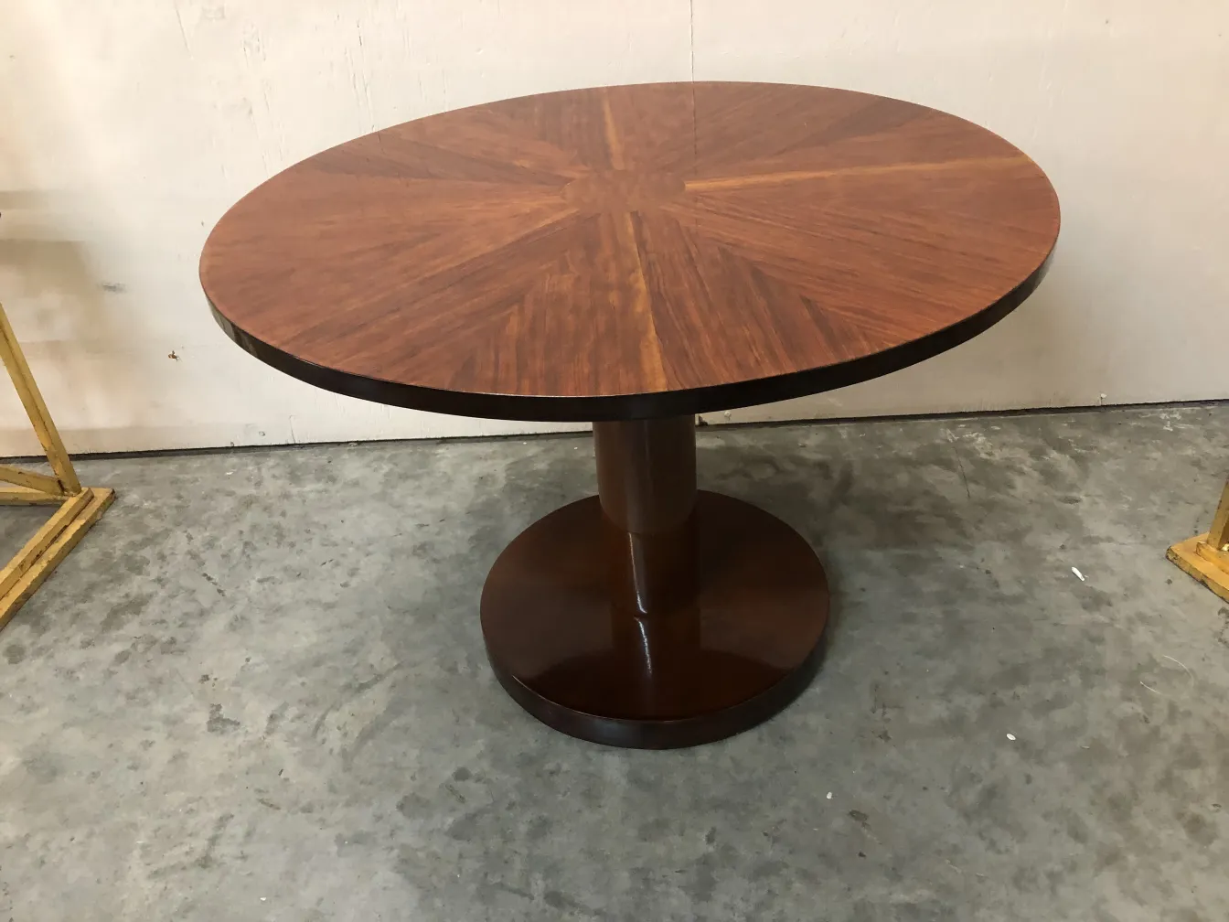 Antique small round table featuring elegant design and solid base, neutral setting.