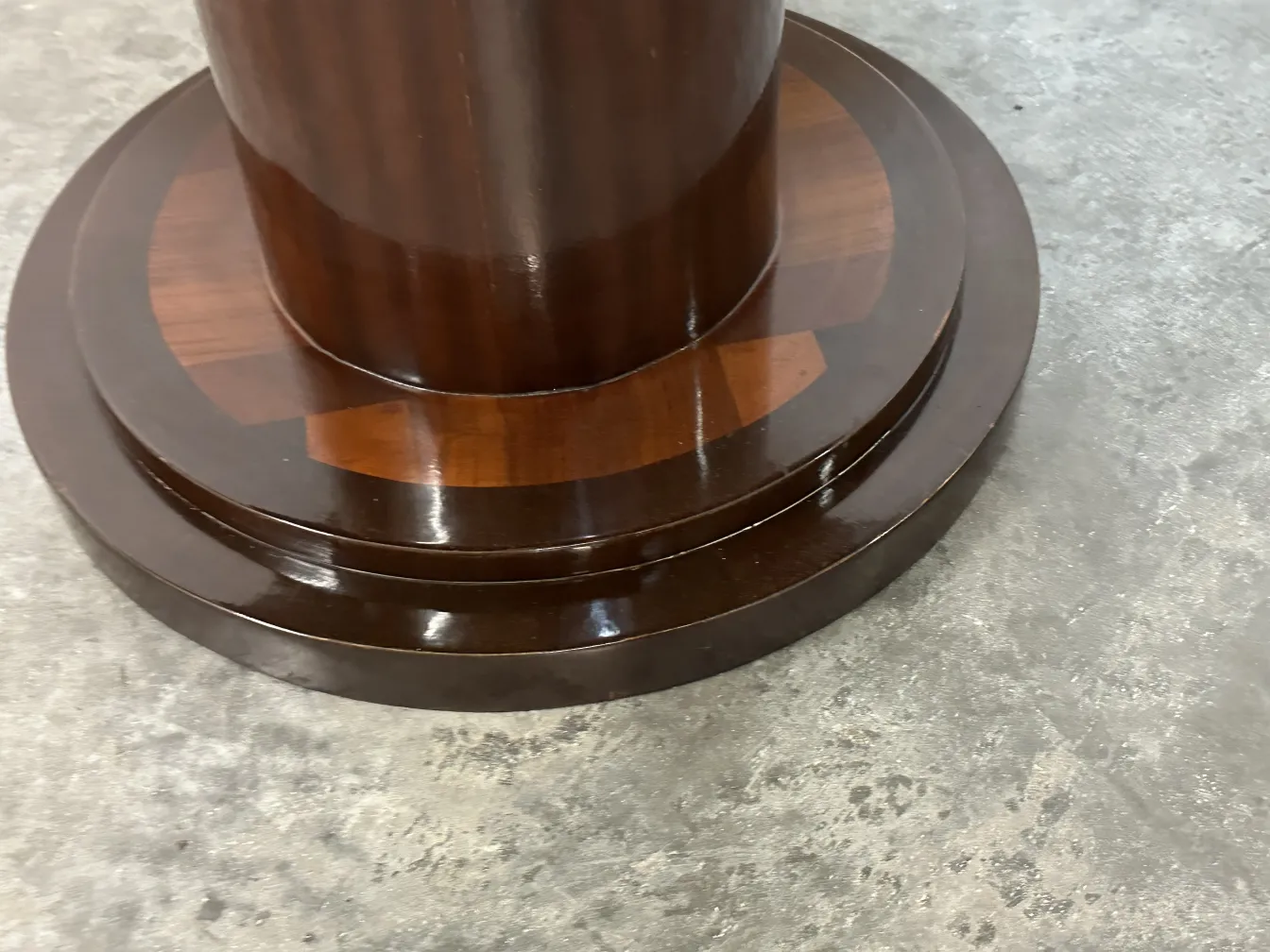 antique small table with a solid base and classic design