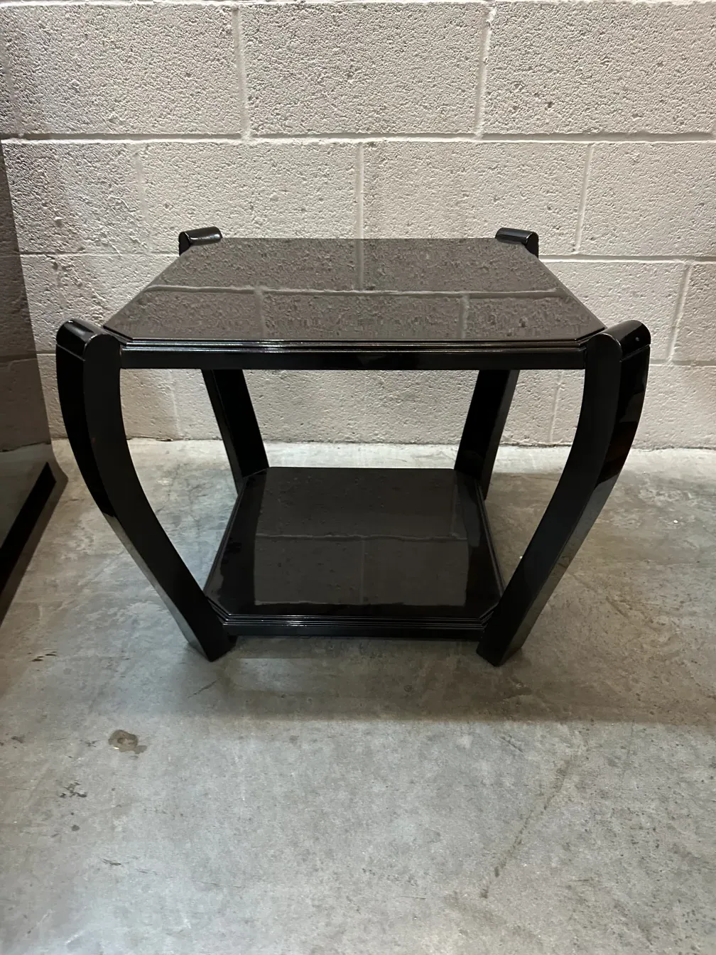 Two elegant antique small tables in a soft room