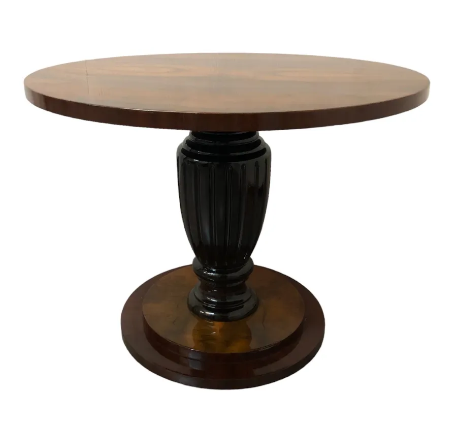 Two antique small tables with round shape and decorative base in classic setting