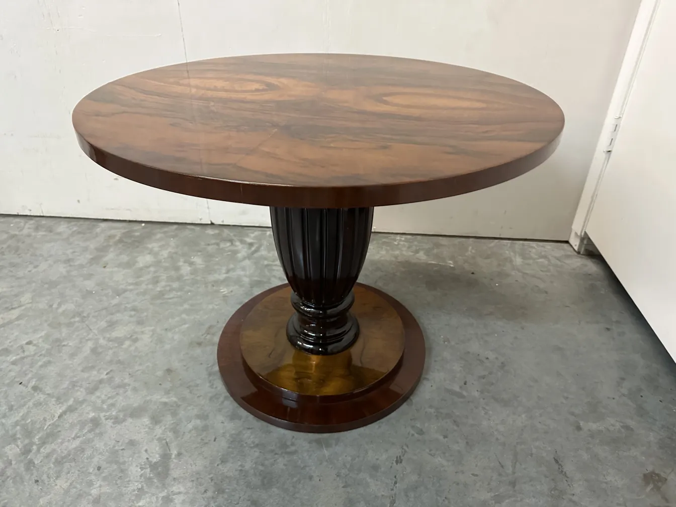 Side view of 2 antique small tables with decorative legs