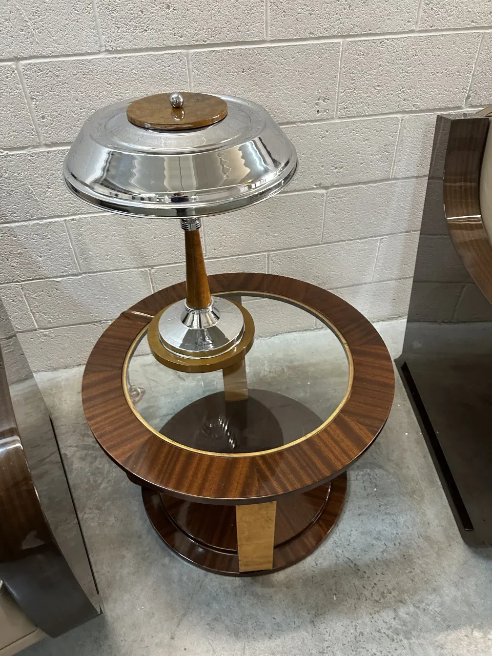 two antique small tables with glass surface and round base in a modern setting.